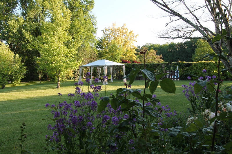 garden with gazebo and flower blooming