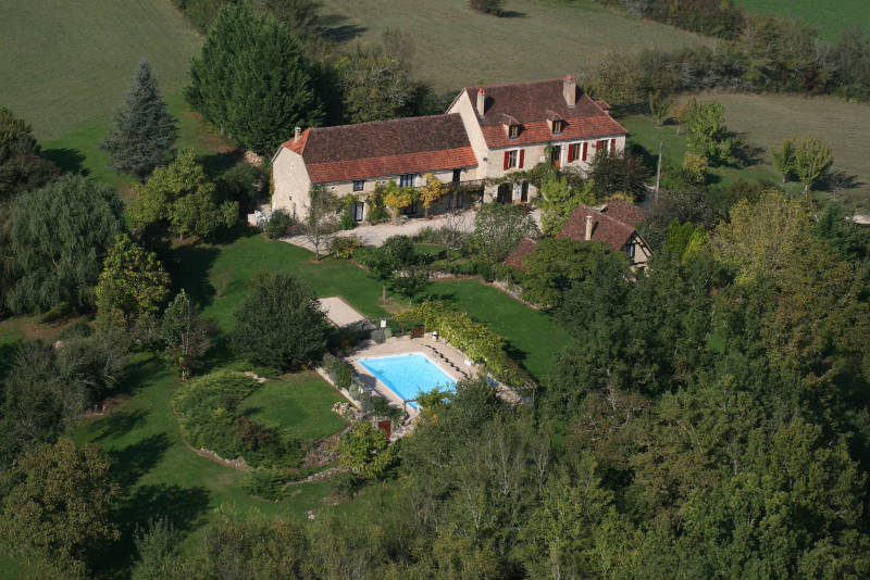 property view from above with the building and swimming pool