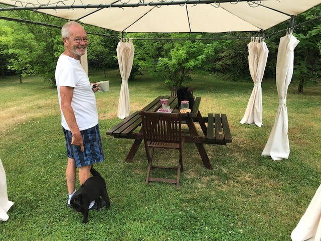tom and the cats under the gazebo with table 